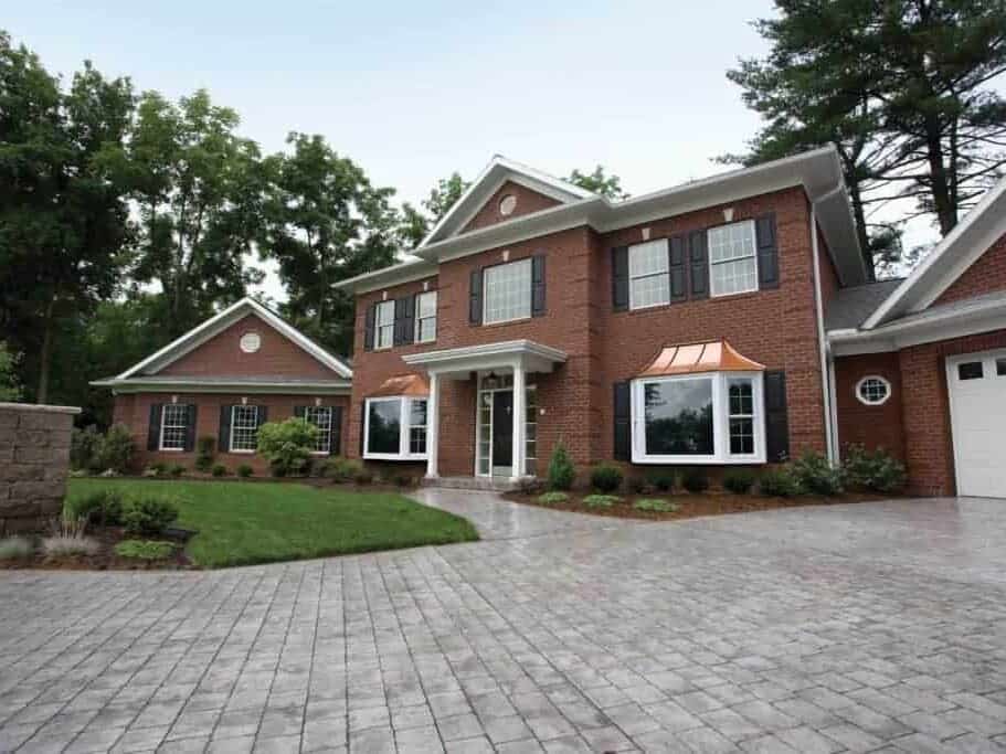 Red brick house with fresh new windows and black shutters