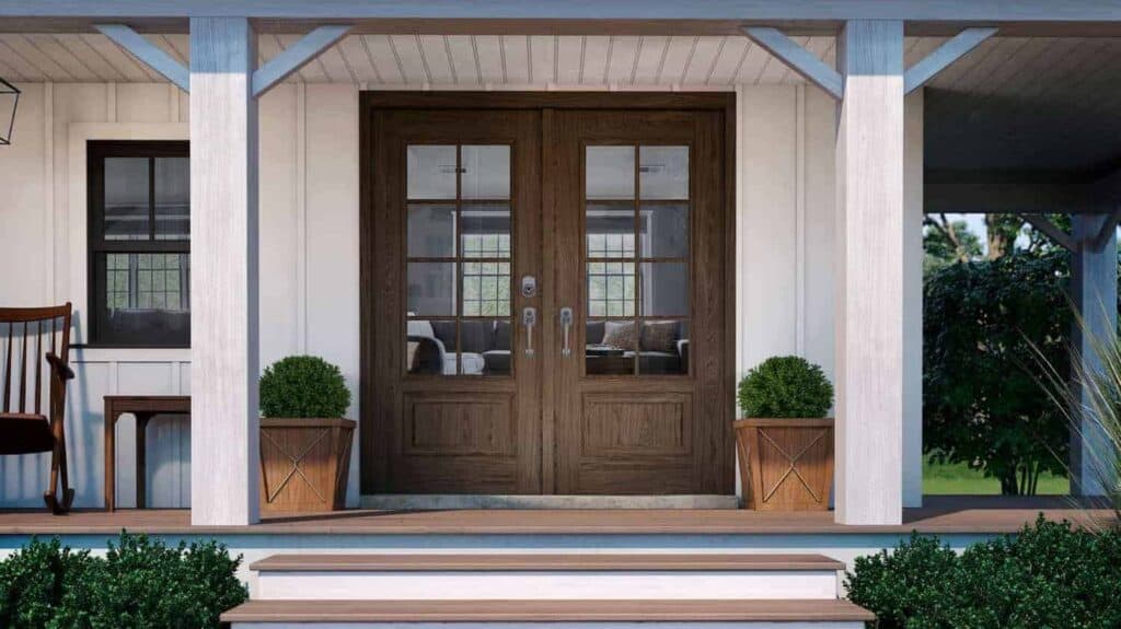 Close-up of wooden front entryway doors on a house with cream-colored siding, provided by Relief Windows, a trusted door company in Mandeville, LA.