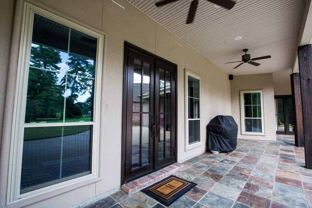 Dark wood french doors on a back porch