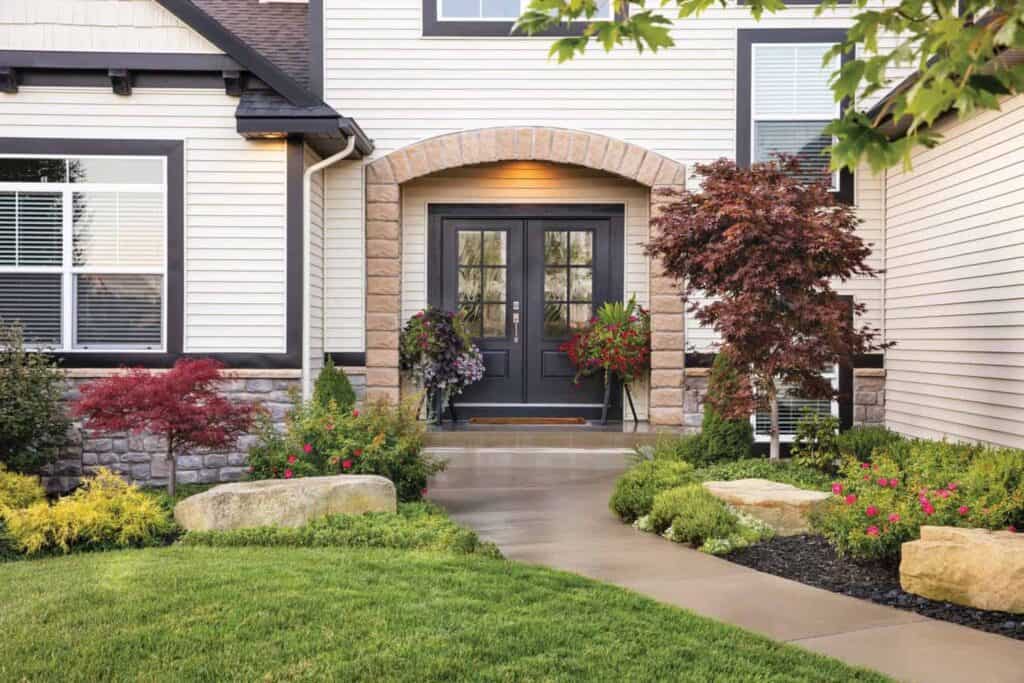 New French entryway doors, installed by Relief Windows on a home with white siding