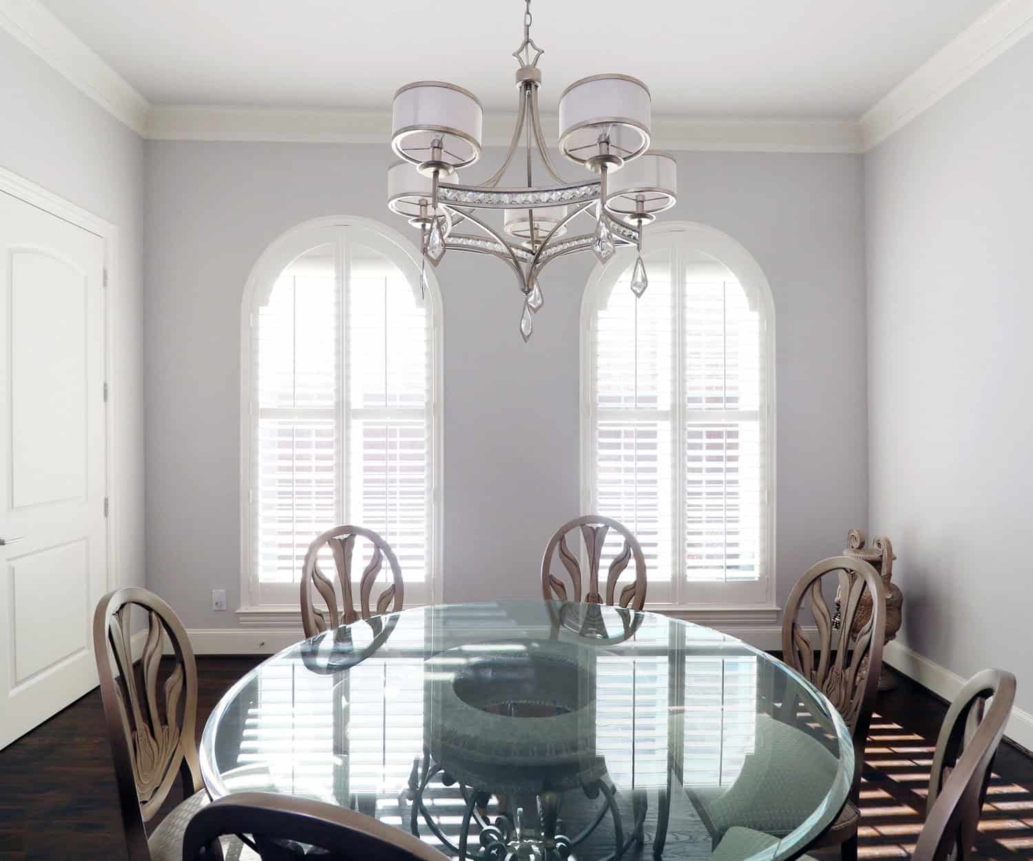 Arched interior dining room windows with custom louvered shutters